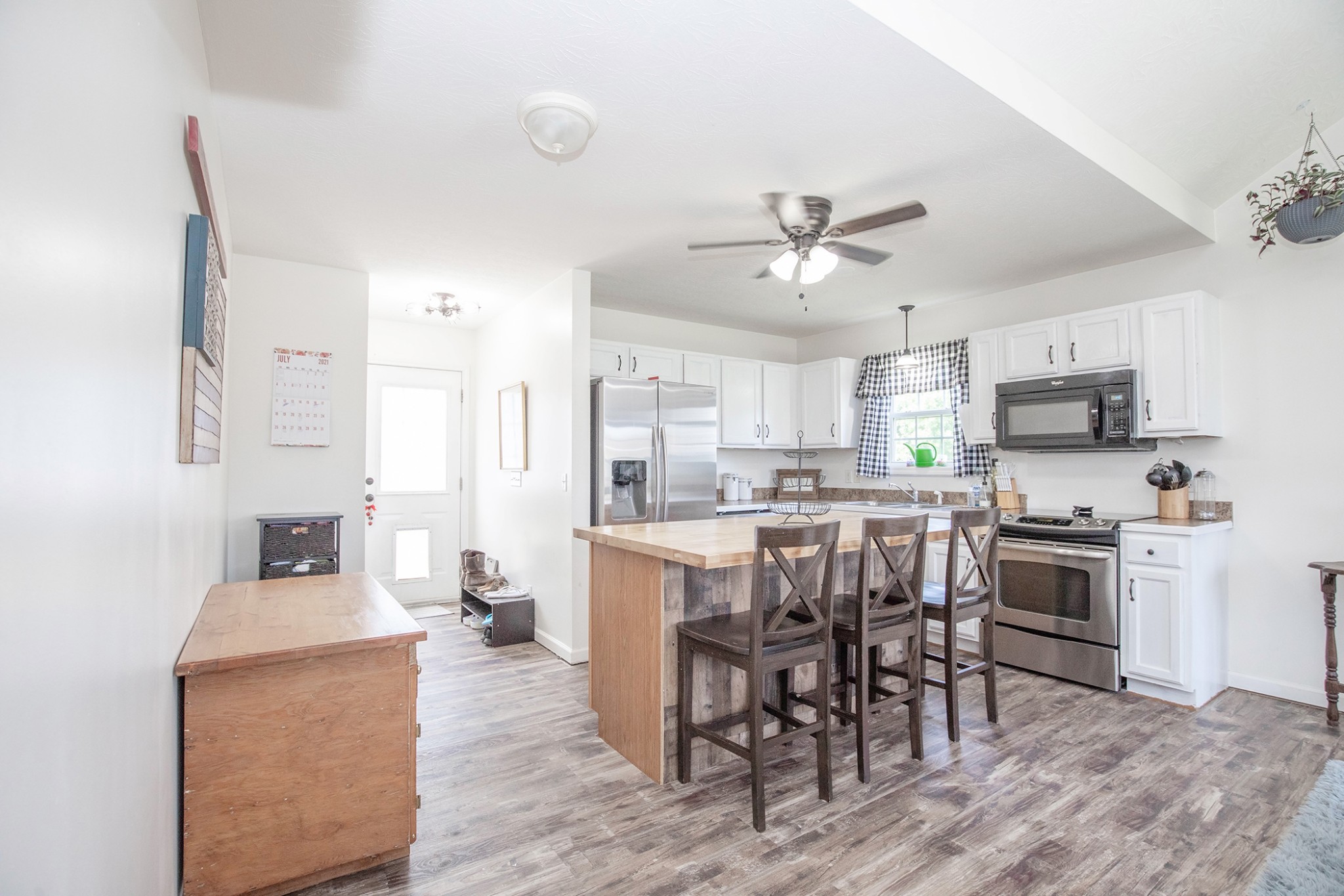 148 Filly Lane Springfield, TN 37172 - Photo 10 of 33 a kitchen with kitchen island granite countertop a stove a sink a dining table and chairs with wooden floor