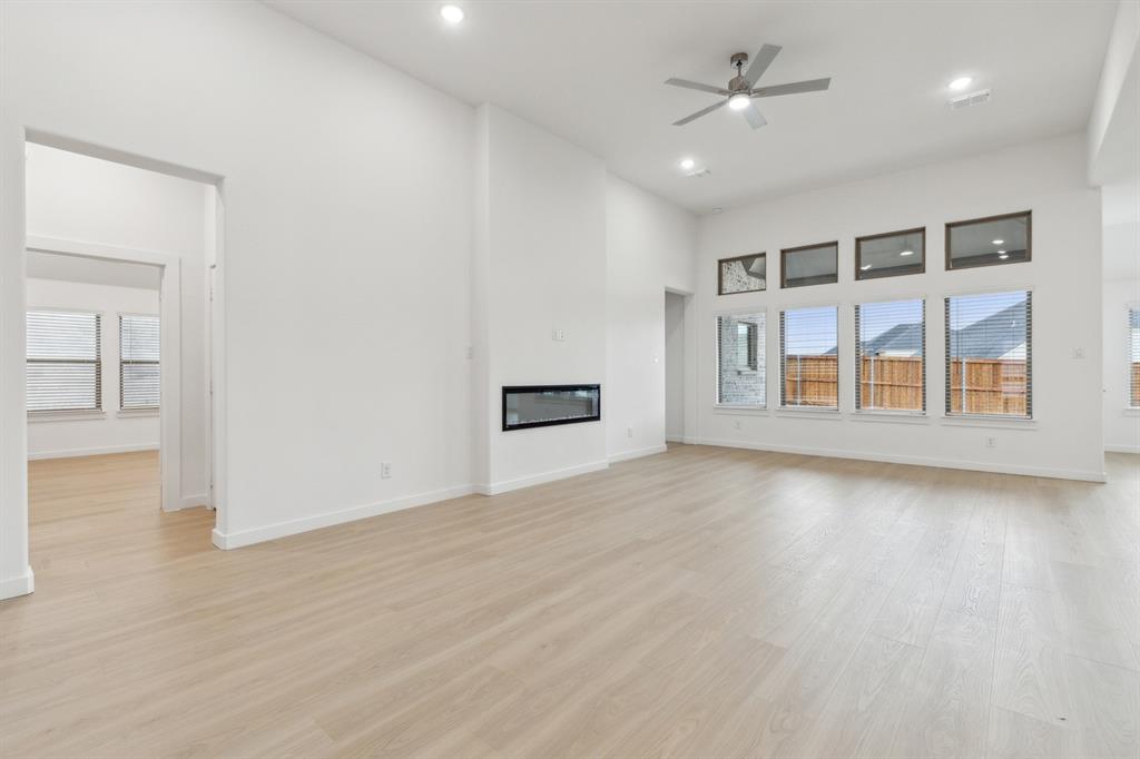 373 Yellowstar Lane Lavon, TX 75166 - Photo 9 of 32 Living Room in the Gilmour II home plan by Trophy Signature Homes – REPRESENTATIVE PHOTO