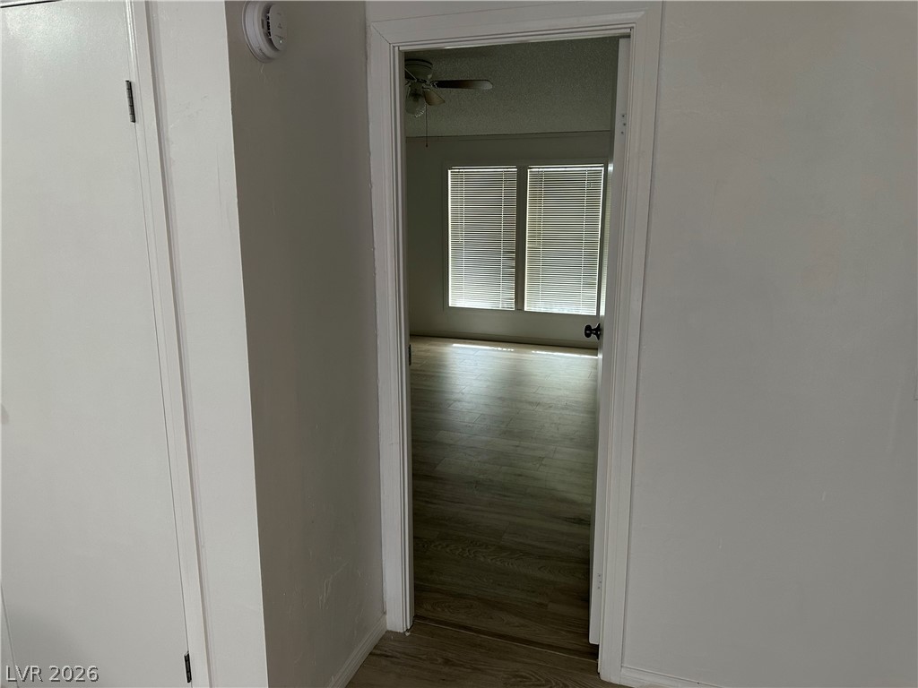 3270 West Simkins Road Pahrump, NV 89060 - Photo 26 of 36 An open doorway reveals wood-look flooring and tall windows inviting plenty of light inside.
