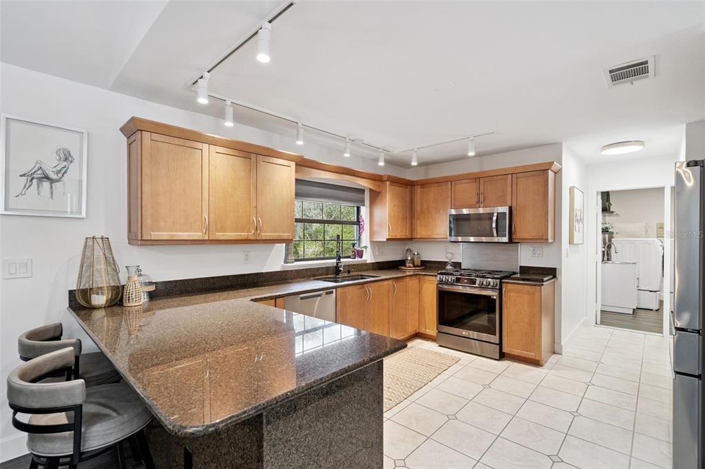 298 Lake Markham Road Sanford, FL 32771 - Photo 11 of 50 a kitchen with stainless steel appliances granite countertop a sink a stove counter space and cabinets