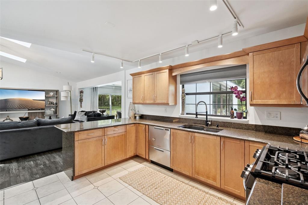 298 Lake Markham Road Sanford, FL 32771 - Photo 12 of 50 a kitchen with lots of counter top space sink and stainless steel appliances