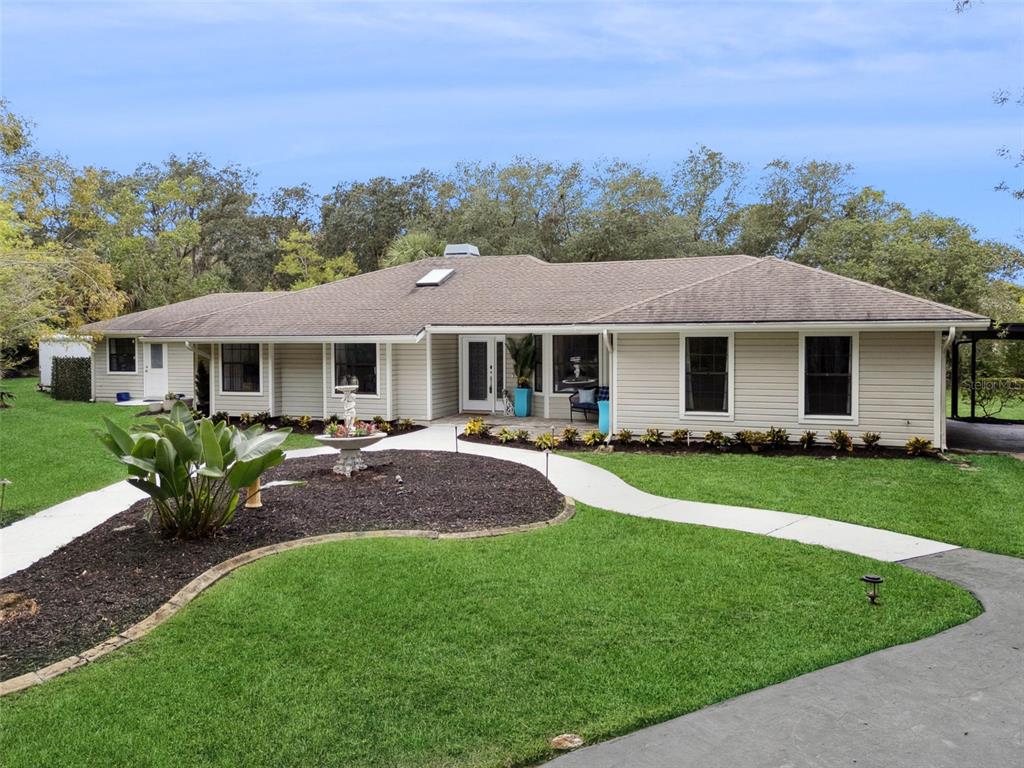 298 Lake Markham Road Sanford, FL 32771 - Photo 2 of 50 a front view of a house with a yard