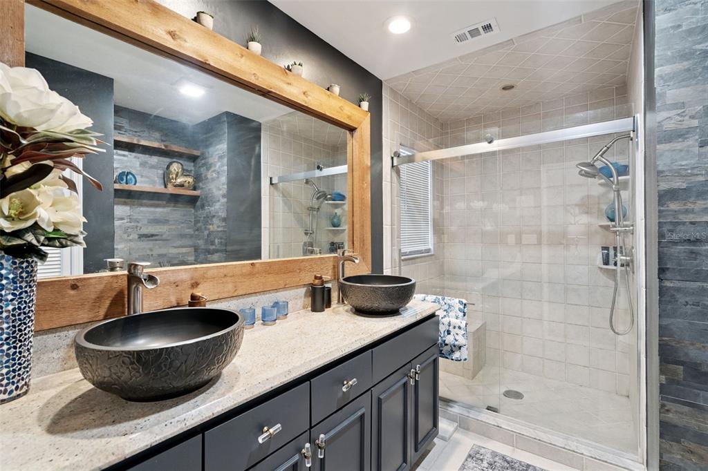 298 Lake Markham Road Sanford, FL 32771 - Photo 22 of 50 a bathroom with a granite countertop sink a mirror and a shower