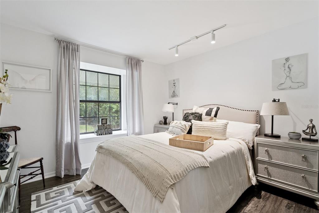 298 Lake Markham Road Sanford, FL 32771 - Photo 24 of 50 a bedroom with a bed and wooden floor