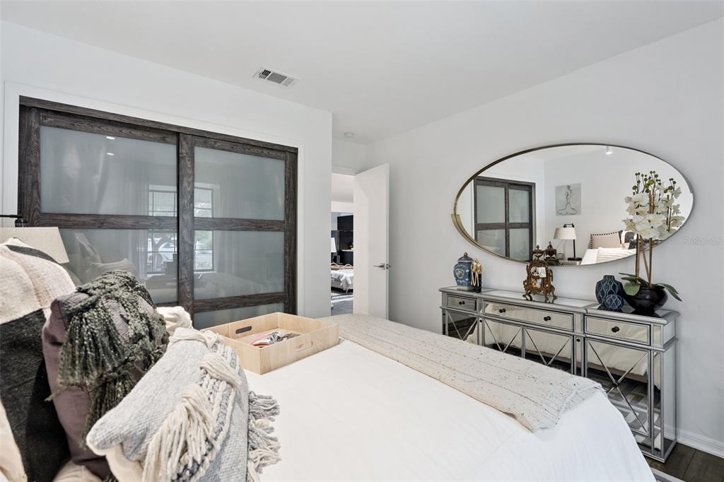 298 Lake Markham Road Sanford, FL 32771 - Photo 25 of 50 a bed room with a bed a mirror and a window