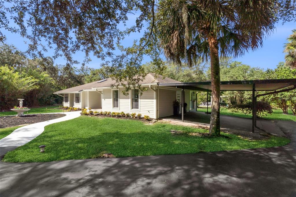 298 Lake Markham Road Sanford, FL 32771 - Photo 33 of 50 a front view of a house with a garden and yard