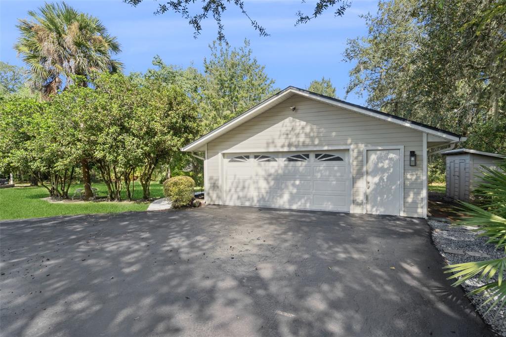 298 Lake Markham Road Sanford, FL 32771 - Photo 34 of 50 a view of a house with a yard and a garage