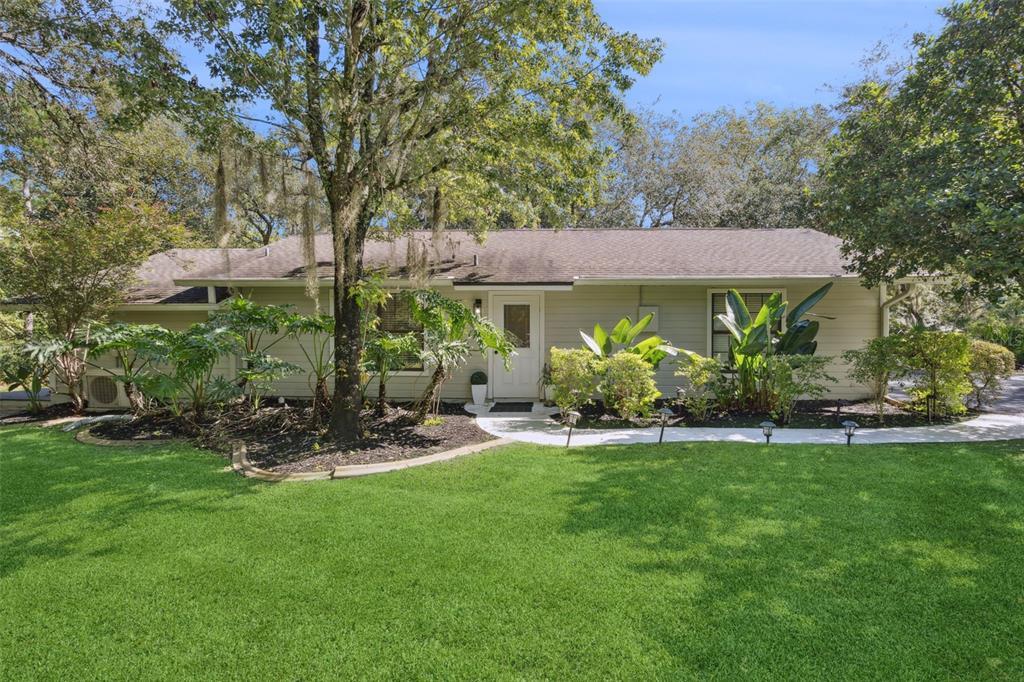 298 Lake Markham Road Sanford, FL 32771 - Photo 35 of 50 a view of a patio with table and chairs under an umbrella