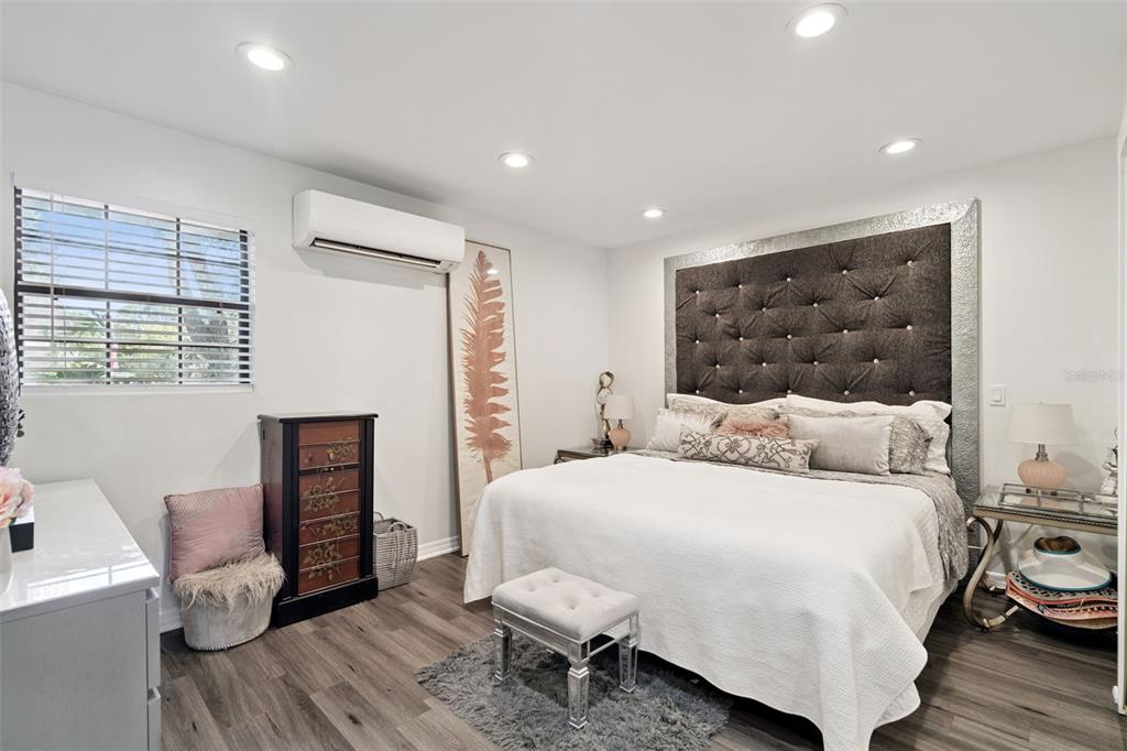 298 Lake Markham Road Sanford, FL 32771 - Photo 38 of 50 a bedroom with a bed and wooden floor