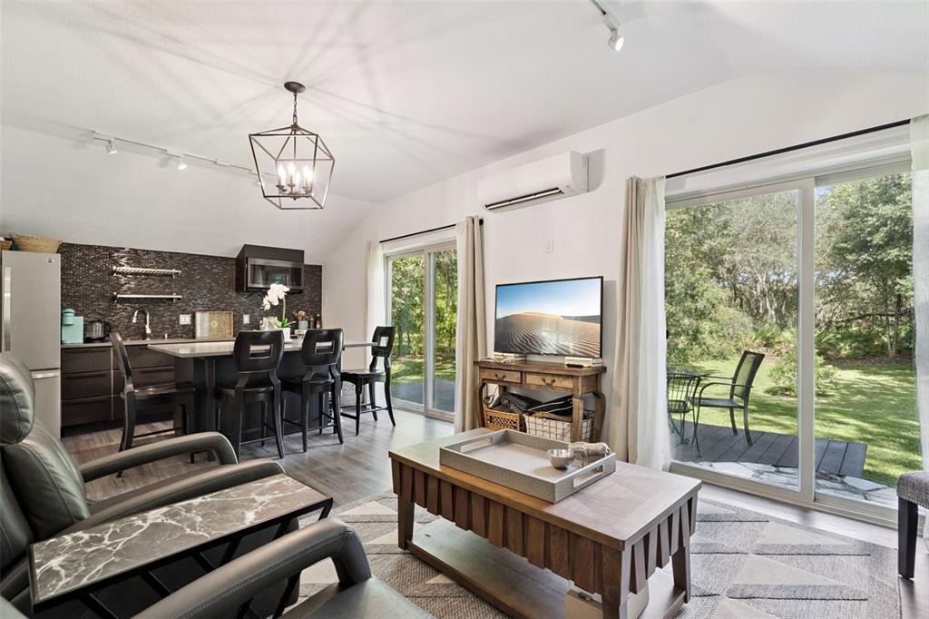 298 Lake Markham Road Sanford, FL 32771 - Photo 43 of 50 a living room with furniture a flat screen tv and a large window