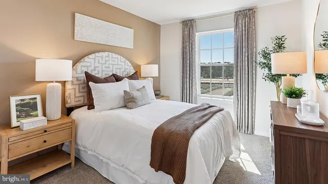 a bedroom with a bed and a lamp on table