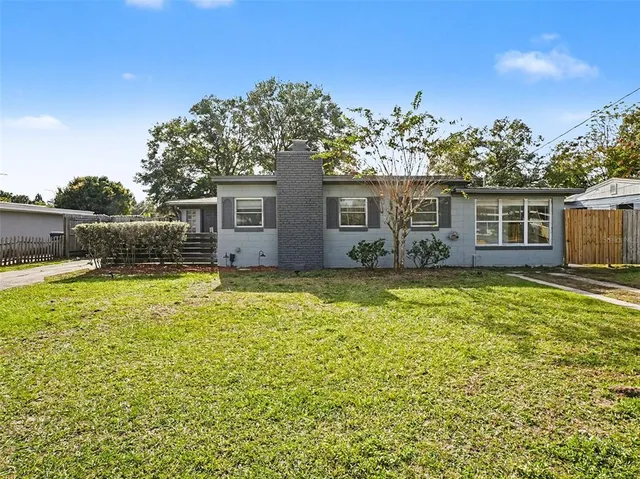 a view of house with a yard