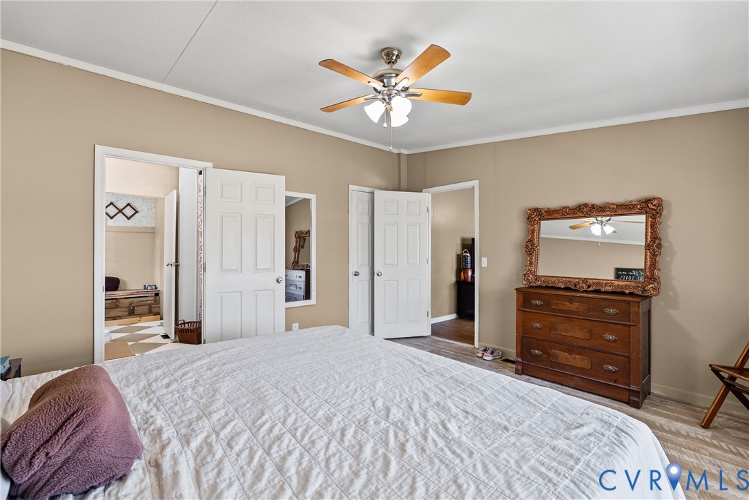 299 Arvin Store Road Keysville, VA 23947 - Photo 12 of 45 a bedroom with a bed and a chandelier