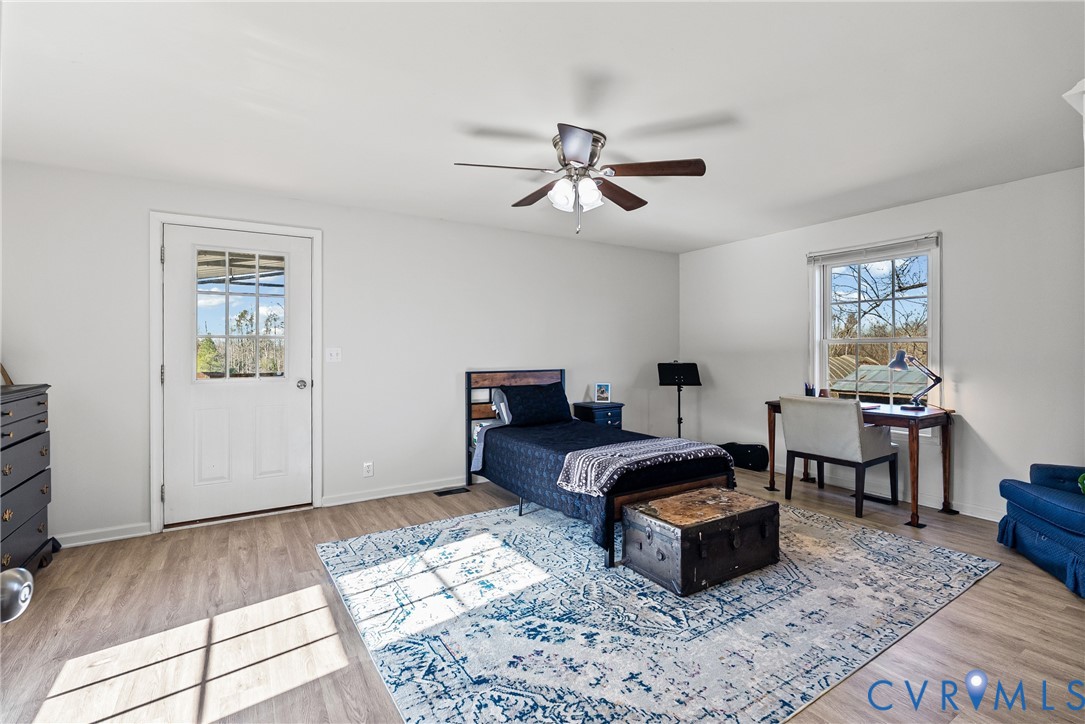 299 Arvin Store Road Keysville, VA 23947 - Photo 16 of 45 a spacious bedroom with a bed a window and table
