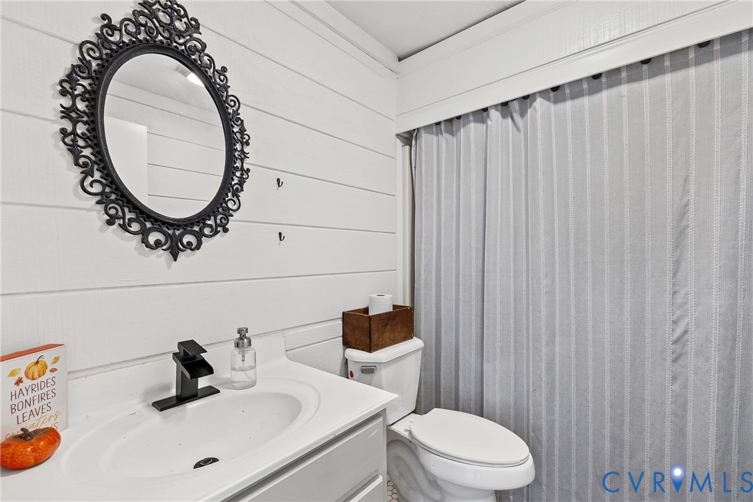 299 Arvin Store Road Keysville, VA 23947 - Photo 22 of 45 a bathroom with a sink a toilet and a mirror