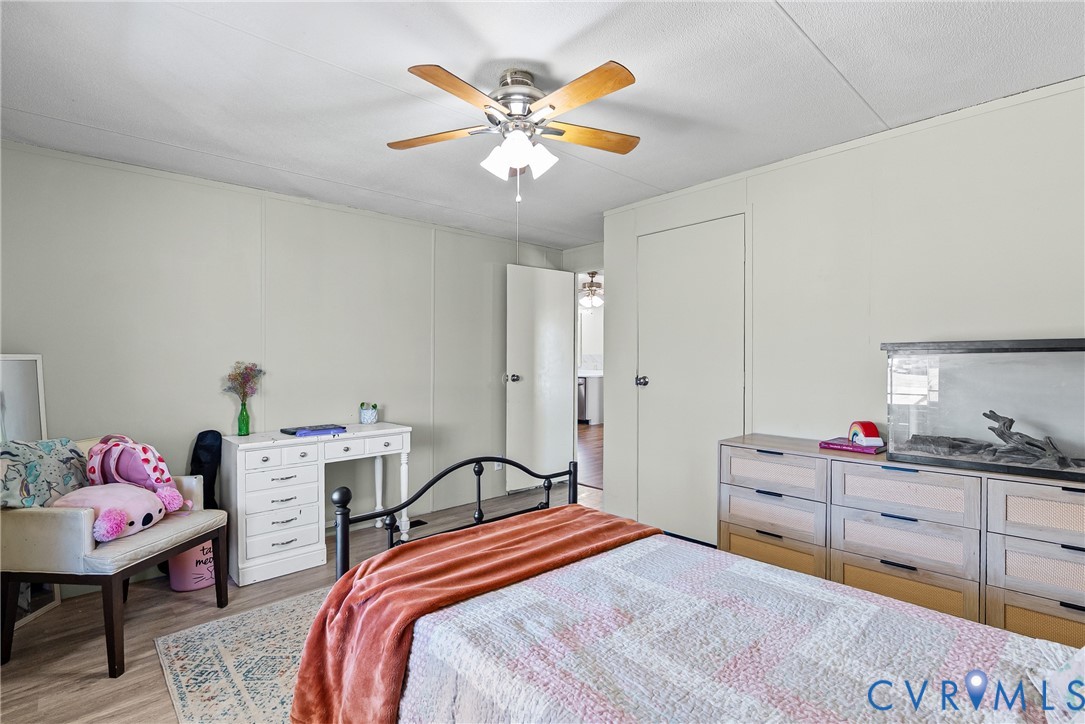 299 Arvin Store Road Keysville, VA 23947 - Photo 24 of 45 a bedroom with a bed and a chandelier