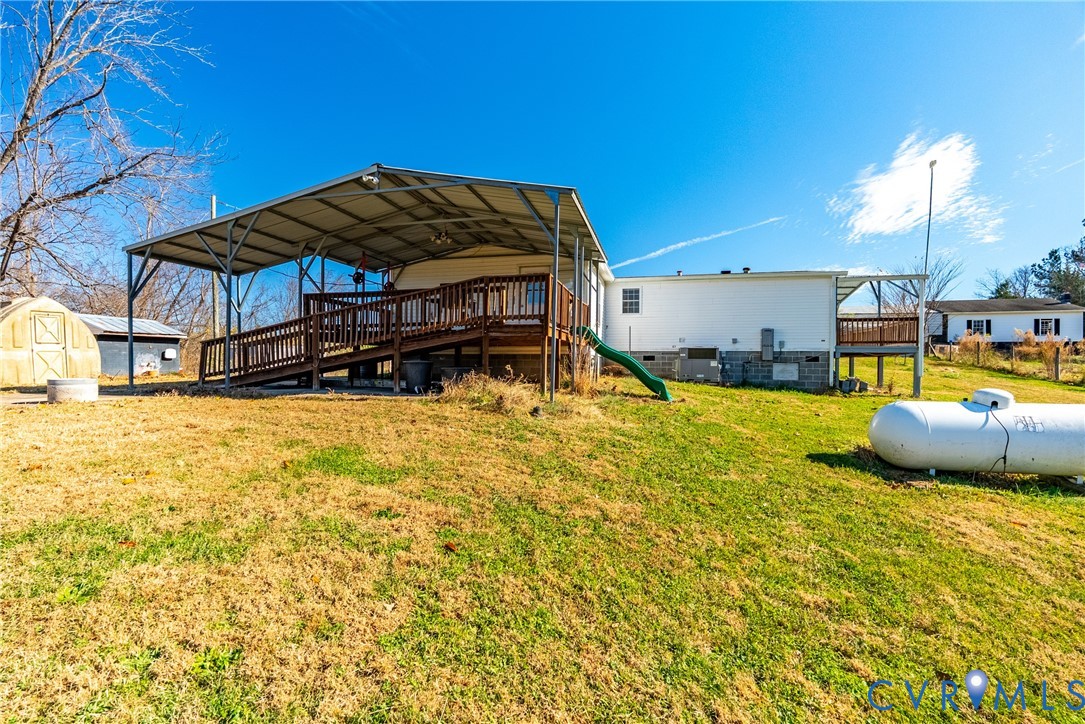 299 Arvin Store Road Keysville, VA 23947 - Photo 36 of 45 a view of a backyard with table and chairs under an umbrella