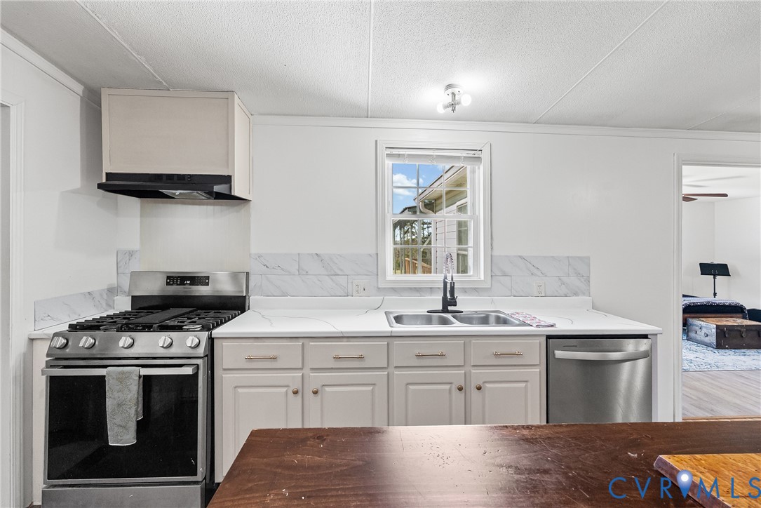 299 Arvin Store Road Keysville, VA 23947 - Photo 4 of 45 a kitchen with stainless steel appliances granite countertop a sink stove and cabinets