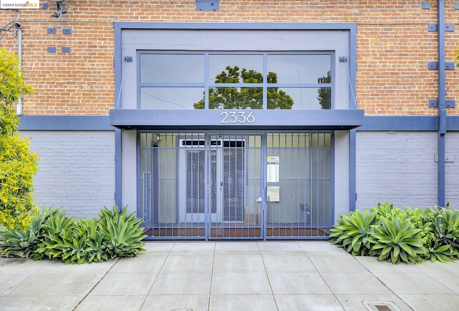a front view of a house with potted plants