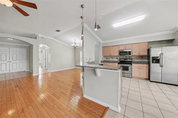a kitchen with stainless steel appliances a refrigerator and a stove top oven