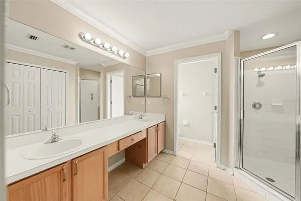 a spacious bathroom with a double vanity sink mirror and shower