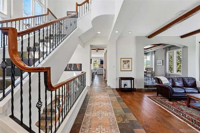 a living room with furniture fireplace and a wooden floor