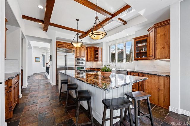 a dining room with wooden floor and furniture
