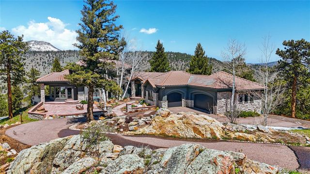 a view of a house with yard and sitting area