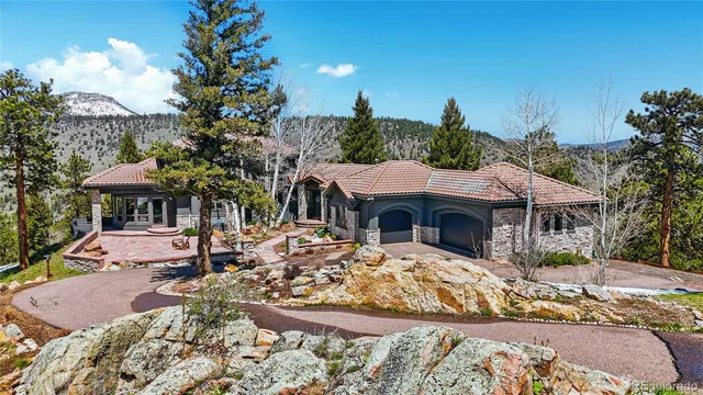 a view of a house with yard and sitting area