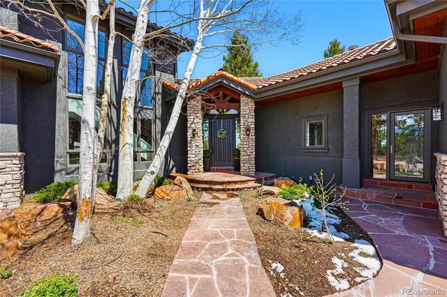 a view of a house with potted plants