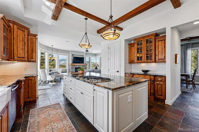 a kitchen with stainless steel appliances granite countertop a stove oven and a refrigerator
