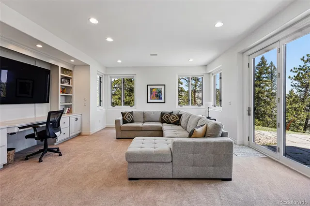 a living room with furniture tv and a large window