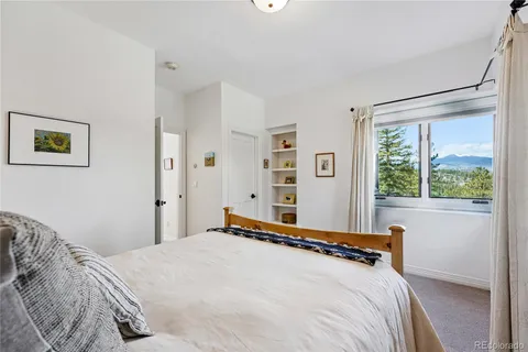 a bedroom with a large bed and a window