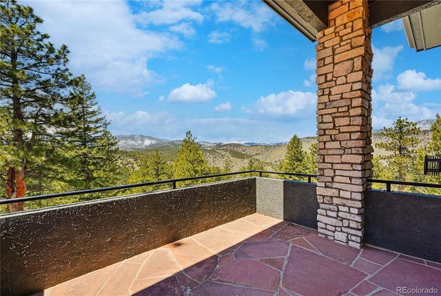 a view of a wooden deck and a backyard
