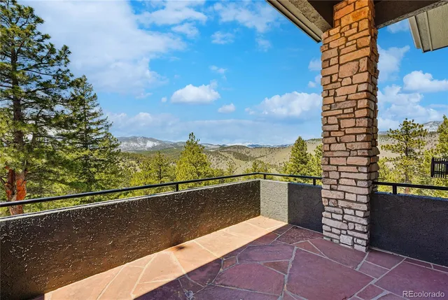 a view of a wooden deck and a backyard