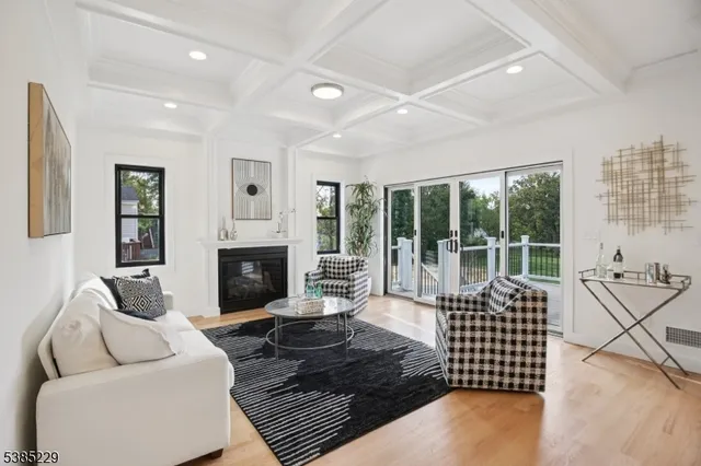 a living room with furniture floor to ceiling window and outside view