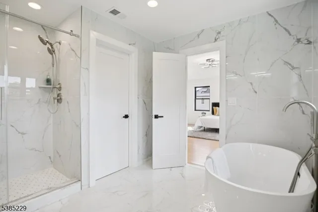 a bathroom with a bathtub and a shower