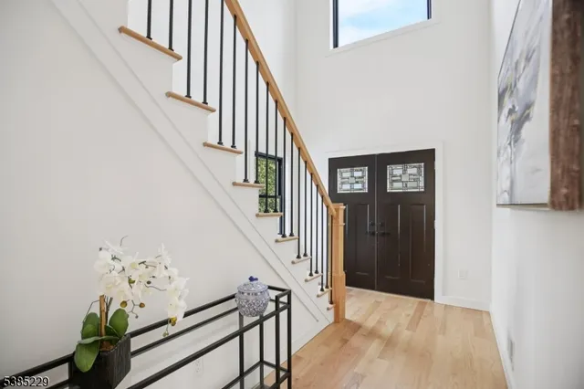 a view of staircase with lots of frames on wall and stairs