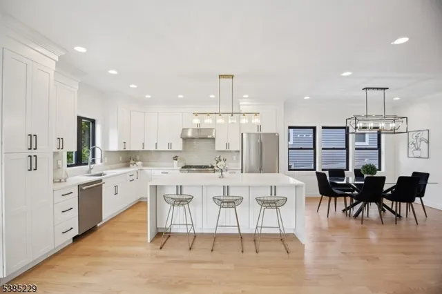 a large kitchen with a table and chairs