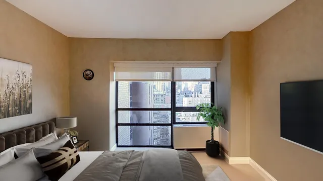a bedroom with a balcony a bed and a large window