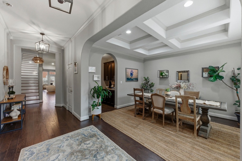 5425 Cherokee Draw Road Austin, TX 78738 - Photo 16 of 40 Hardwood floors guide you through a refined dining area with a coffered ceiling, perfect for entertaining.