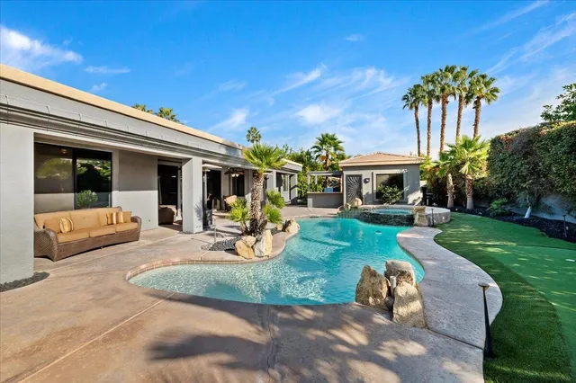 a view of a house with a yard balcony and furniture