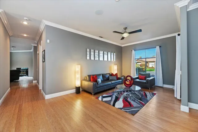 a living room with furniture or wooden floor and a chandelier