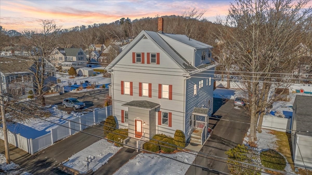a view of a big house with a big yard and large tree