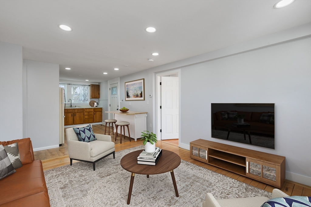 129 Friend Street, Unit 2 Amesbury, MA 01913 - Photo 7 of 27 a living room with furniture and a flat screen tv