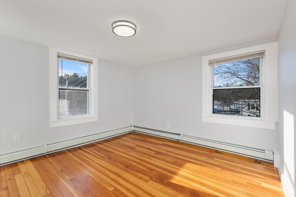 129 Friend Street, Unit 2 Amesbury, MA 01913 - Photo 10 of 27 a view of a room that has a window and wooden floor