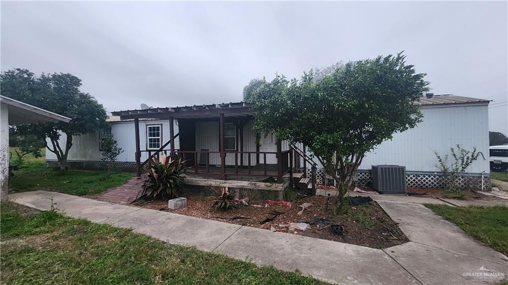 32656 San Carlos Road, Unit 2 Los Fresnos, TX 78566 - Photo 2 of 15 a front view of a house with garden