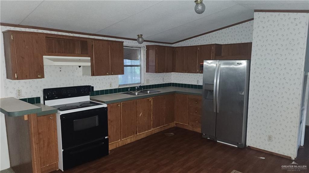 32656 San Carlos Road, Unit 2 Los Fresnos, TX 78566 - Photo 10 of 15 a kitchen with a refrigerator and a sink