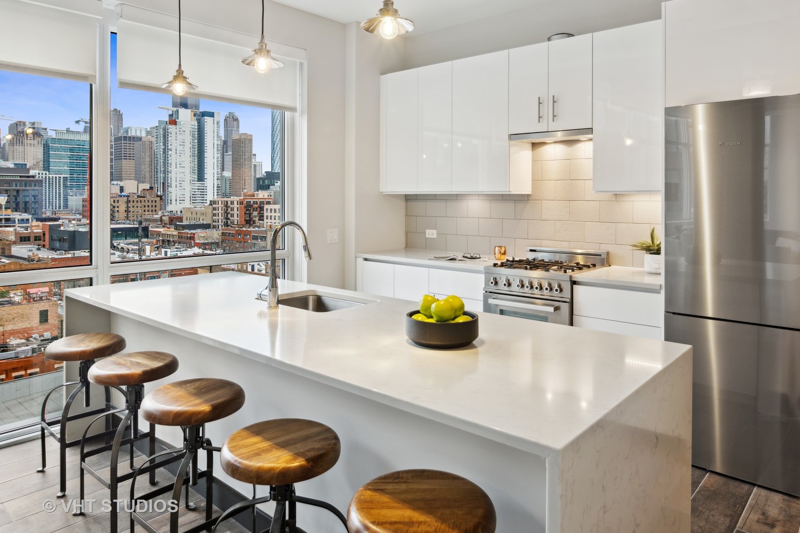 171 North Aberdeen Street, Unit 806 Chicago, IL 60607 - Photo 7 of 18 a kitchen with a sink a stove and chairs