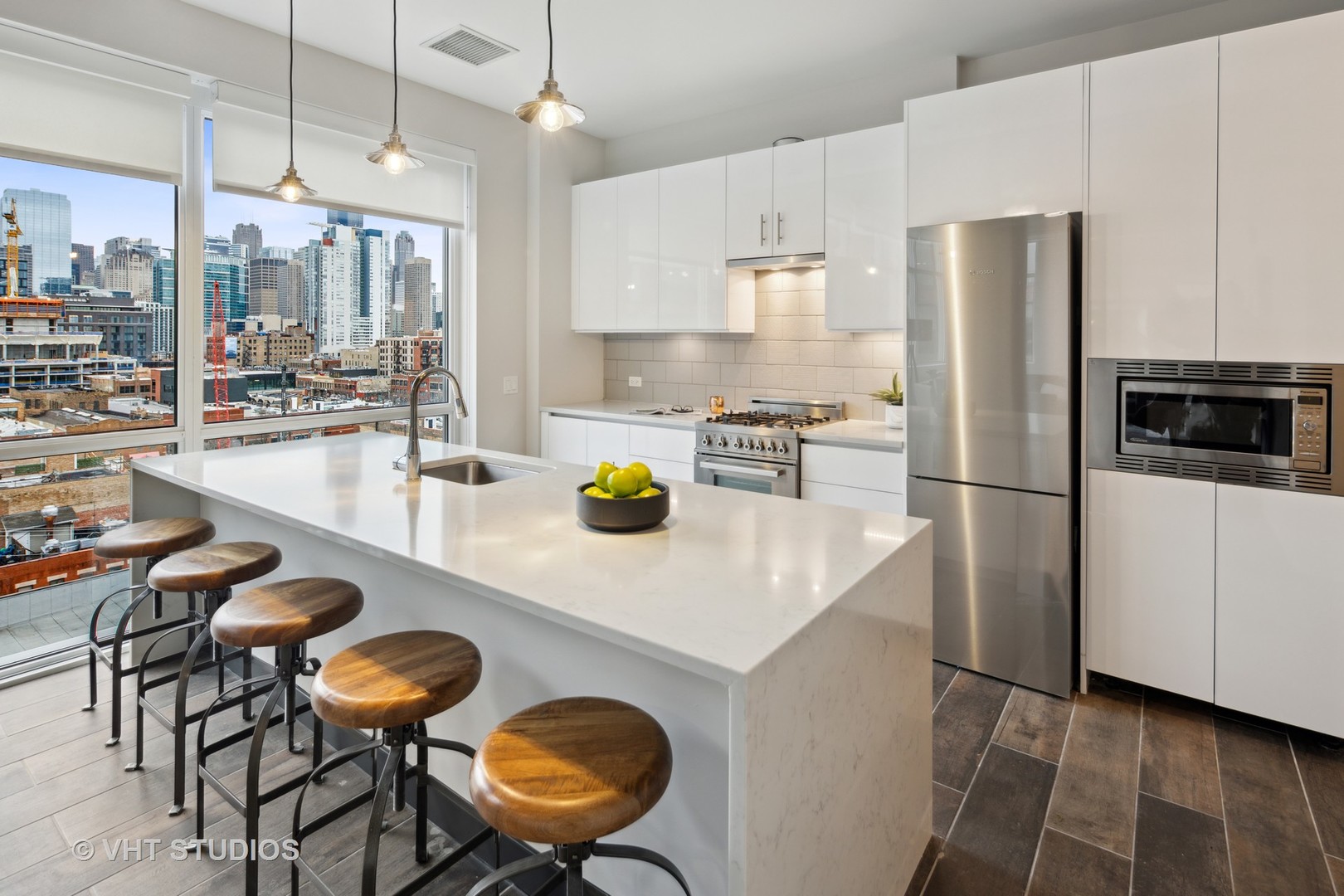 171 North Aberdeen Street, Unit 806 Chicago, IL 60607 - Photo 8 of 18 a kitchen with a refrigerator a stove a dining table and chairs with wooden floor